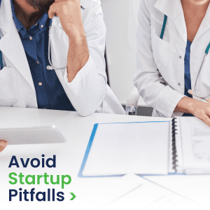 Two medical professionals looking at paperwork on a desk, with "Avoid Startup Pitfalls" words