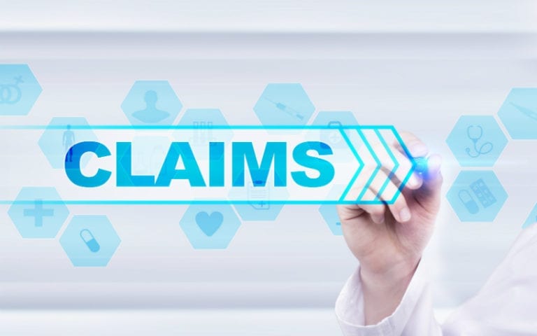 A person holds a marker, pointing to the word "CLAIMS" on a transparent screen with various medical and insurance icons in the background.