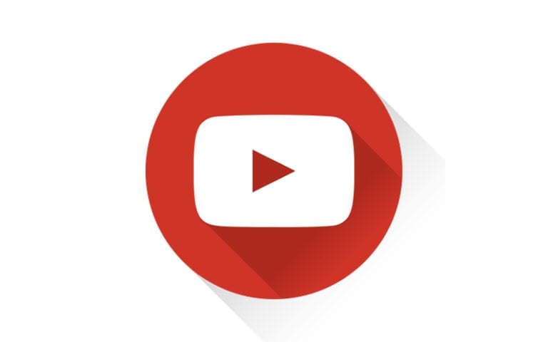 A red circle with a white play button icon in the center, representing the YouTube logo, on a white background.