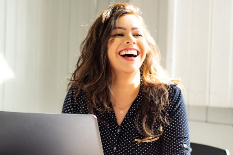 Patient smiling and laughing at computer