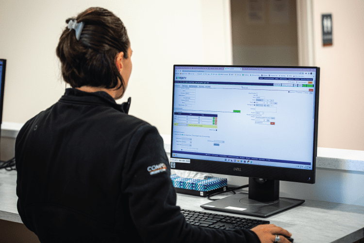 Urgent Care Front Desk Staff Working On Technology