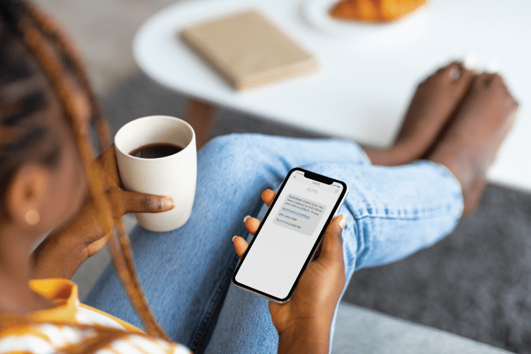 woman sitting looking at mobile phone