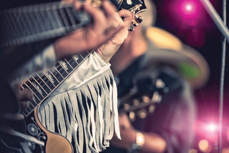 Closeup of guitarist hands depicting the Austin music scene.