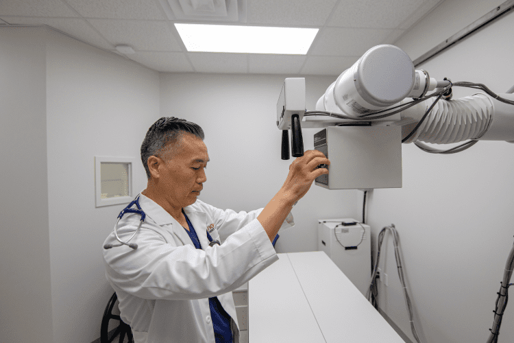 Doctor adjusting an xray machine